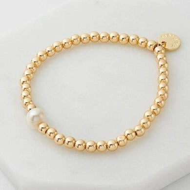 gold ealstic bracelet with single pearl