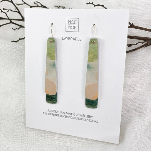 Pair of layered earrings on a Moe Moe branded card  background.