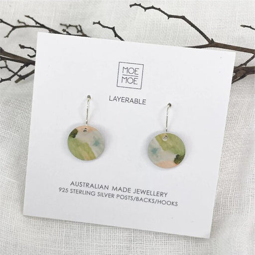 Pair of earrings on a Moe Moe branded card aura drop