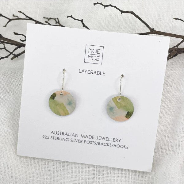 Pair of earrings on a Moe Moe branded card aura drop
