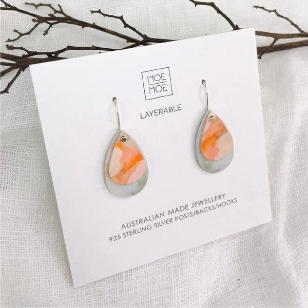 Teardrop-shaped earrings on a Moe Moe branded card 