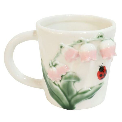 Ceramic mug with a ladybug and floral design 