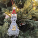 Decorative Christmas ornament of a kangaroo with a Santa hat on a Christmas tree.