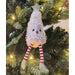 Decorative Christmas tree ornament with a face and striped legs 
