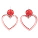 Heart-shaped earrings with red heart charms 