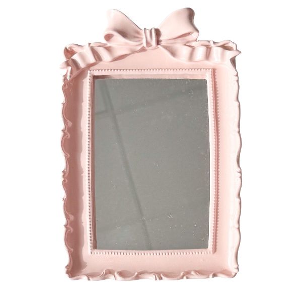 Pink decorative mirror with a bow 