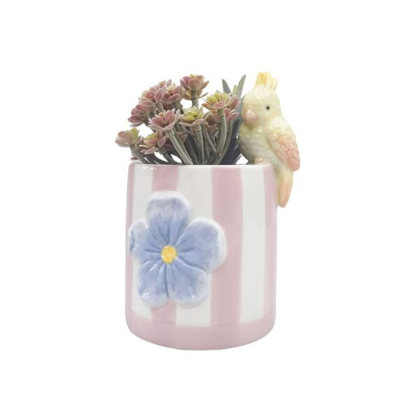 Small ceramic planter with a blue flower design, pink stripes, and a small bird figurine o