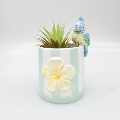 Decorative planter with a small bird figurine 