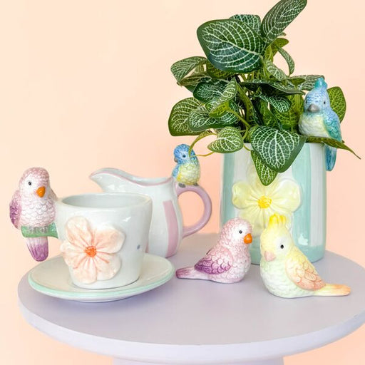 Decorative items including a pitcher, saucer, and bird figurines 