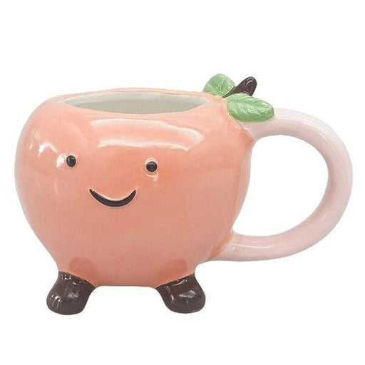 Pink peach-shaped mug with a smiling face  