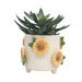 Decorative planter with sunflower designs on a white background