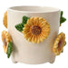 Ceramic pot with sunflower designs on a white background