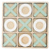 Tic-tac-toe game board with green and white pieces 
