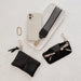 Collection of black accessories including a phone case, keychain, and pouch 
