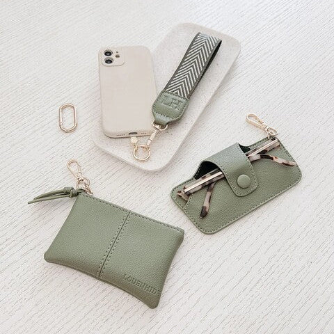 Set of green leather accessories including a pouch, key case