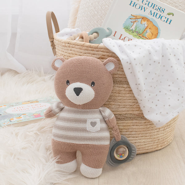 knitted bear toy holding rattle