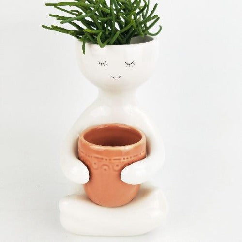 person holding pink pot